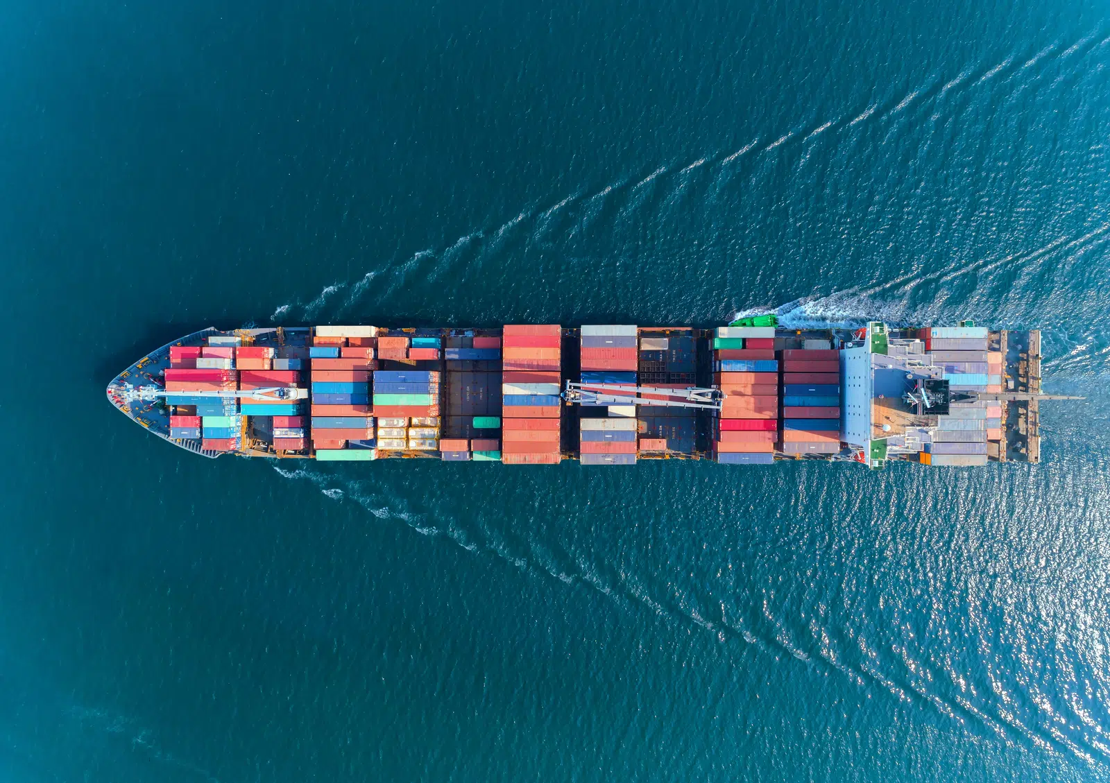 Container ship crossing open blue water